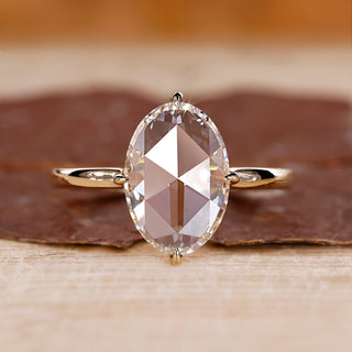 Oval rose cut engagement ring set in yellow gold with a solitaire setting.