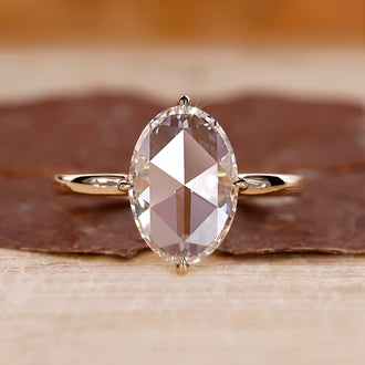 Oval rose cut engagement ring set in yellow gold with a solitaire setting.