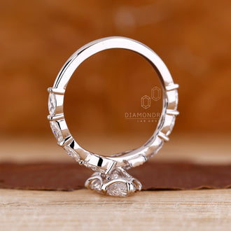 Custom diamond ring with marquise cut diamonds and pave setting.