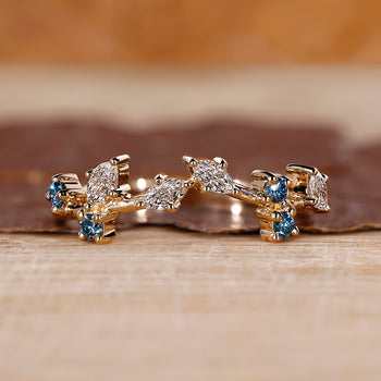 Marquise and round wedding band designed as a cluster wedding band.