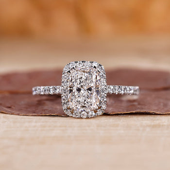Elongated cushion cut diamond ring in a delicate setting.
