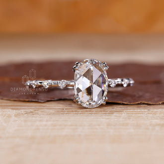 White gold ring with oval rose cut diamond and double prong setting.