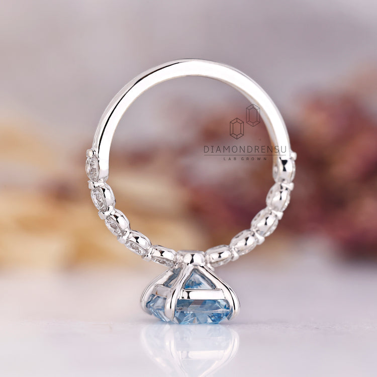 Lab Grown Diamond blue cushion cut ring with shared prong setting.