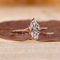 Unique gold engagement ring with marquise cut.