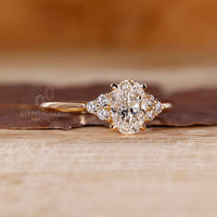 Yellow gold ring with oval and round diamonds.