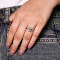 Round cut hidden halo ring with radiant cut diamond and distance pave.