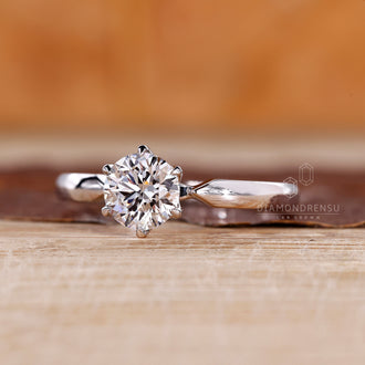 White gold ring with round diamond solitaire and custom design.