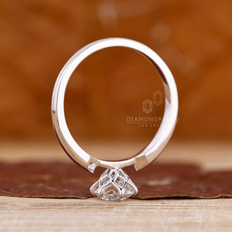 Custom diamond ring featuring round diamond solitaire with tapered shank.