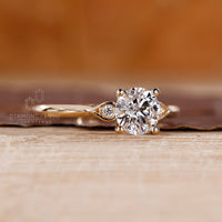 Handmade ring featuring pear shape outline and round side diamonds.