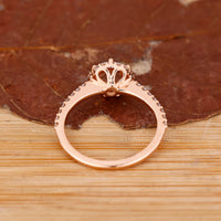 Round cut halo diamond ring in rose gold handmade jewelry.
