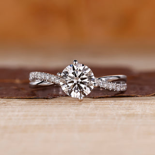 Round diamond ring with a twisted pave band and 4 prong setting.