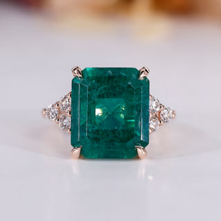 Emerald gemstone ring in rose gold setting.