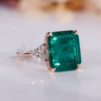 Rose gold ring with tapered shank and emerald center.