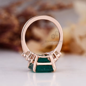 Custom emerald and diamond engagement ring.