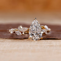 Prong setting ring paired with a pear cut engagement ring.
