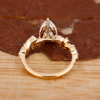 Diamondrensu engagement ring with marquise side stones.