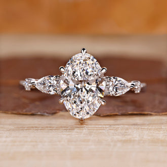 Oval cut diamond ring with five stone design in white gold.