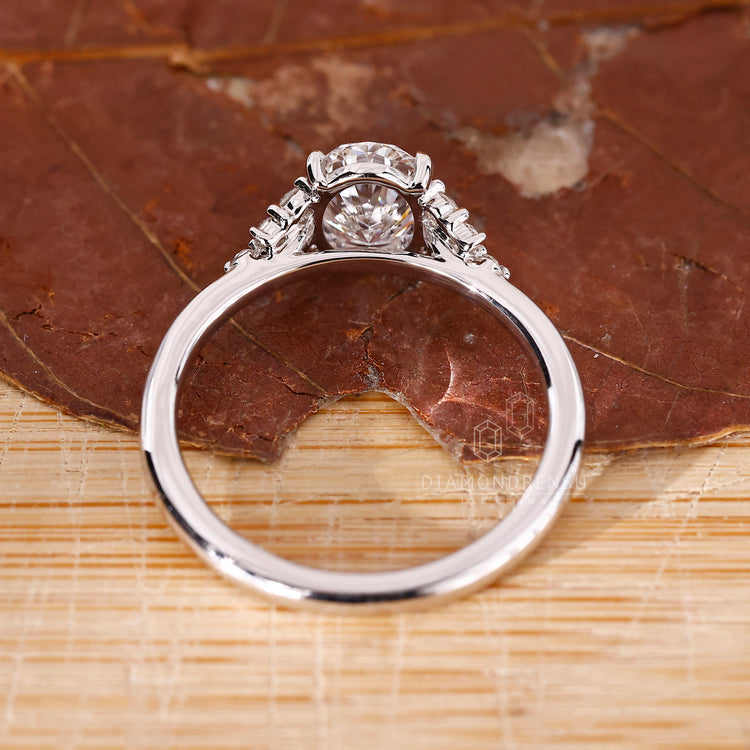 Handmade jewelry featuring a round cut diamond in a cathedral setting.