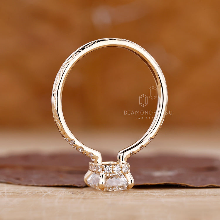 Handmade ring with hidden halo and cushion cut centerpiece.