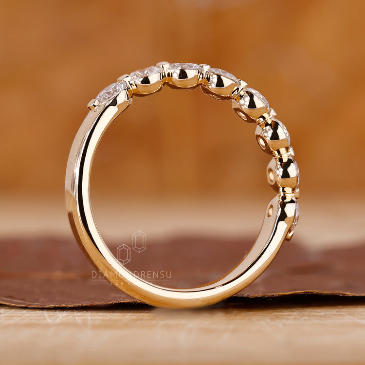 Round diamond wedding band with shared prong setting.