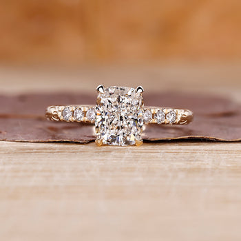Cushion cut hidden halo engagement ring with lab grown center diamond.