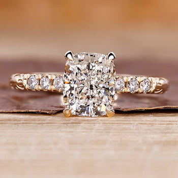 Cushion cut hidden halo engagement ring with lab grown center diamond.