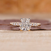 Cushion cut hidden halo engagement ring with lab grown center diamond.