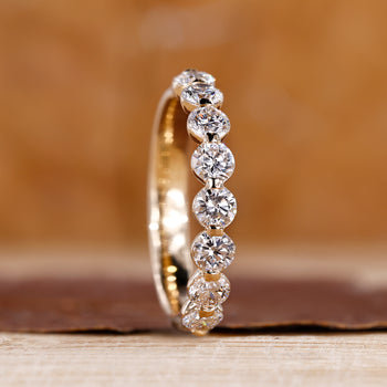 Half eternity band with brilliant diamond accents.