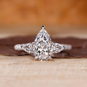 Pear cut diamond ring in white gold with three stone design.