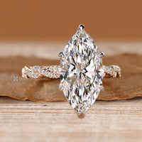 Two tone style adds contrast to this marquise engagement ring.