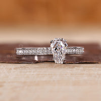 Coffin cut engagement ring with hidden halo and cathedral design.