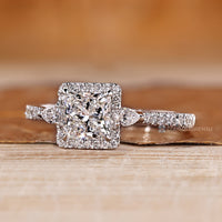 Pear side stones complement the princess center stone beautifully.