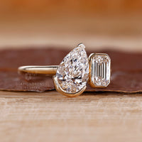 LGI certified pear emerald toi et moi diamond ring.