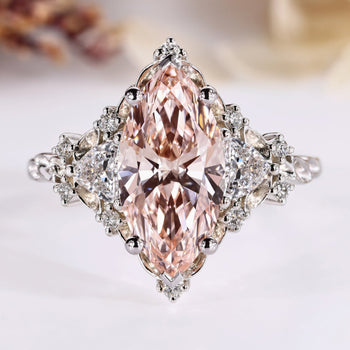 Pink marquise diamond ring with trillion and round side stones.