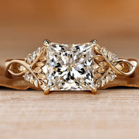 Princess cut diamond ring with round side stones.