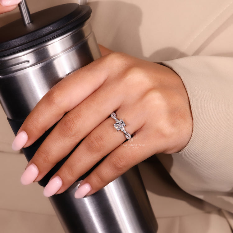 Twisted engagement ring with 4 prong claw setting in white gold.