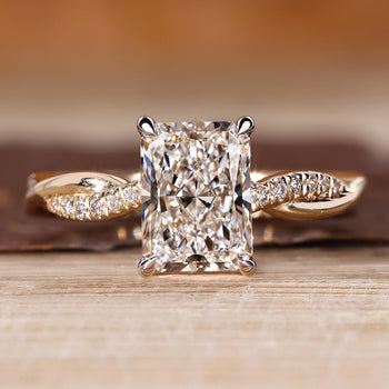 Radiant cut diamond ring with twisted shank and twisted pave band design.