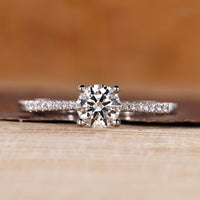 Round diamond ring with round cut pave setting and tapered shank.