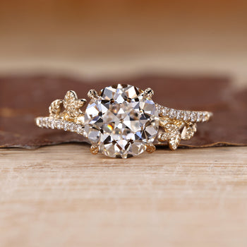 Nature inspired ring with round old european cut diamond leaf design.
