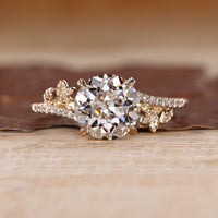Nature inspired ring with round old european cut diamond leaf design.