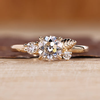 Nature inspired engagement ring with round old European cut diamond.
