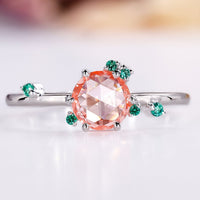 Round rose cut diamond ring with green emerald and peach gemstones.