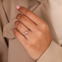 Round rose cut center stone ring with peach gemstone accents.