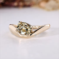 Solitaire style highlights the light yellow center stone.