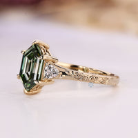 Green hexagon shape diamond ring with a six claw prong setting.
