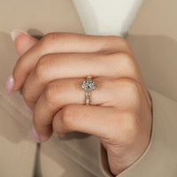 Oval lab grown diamond ring with four claw prongs.