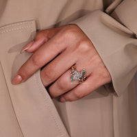 Round and marquise cut emerald gemstone with round side stones.