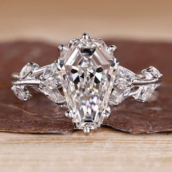 Nature inspired engagement ring with coffin center stone and marquise side stones.