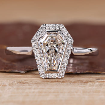 Round halo diamond ring with coffin center stone and bezel setting.