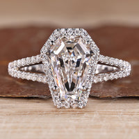 Split shank diamond ring with coffin center stone and halo style.